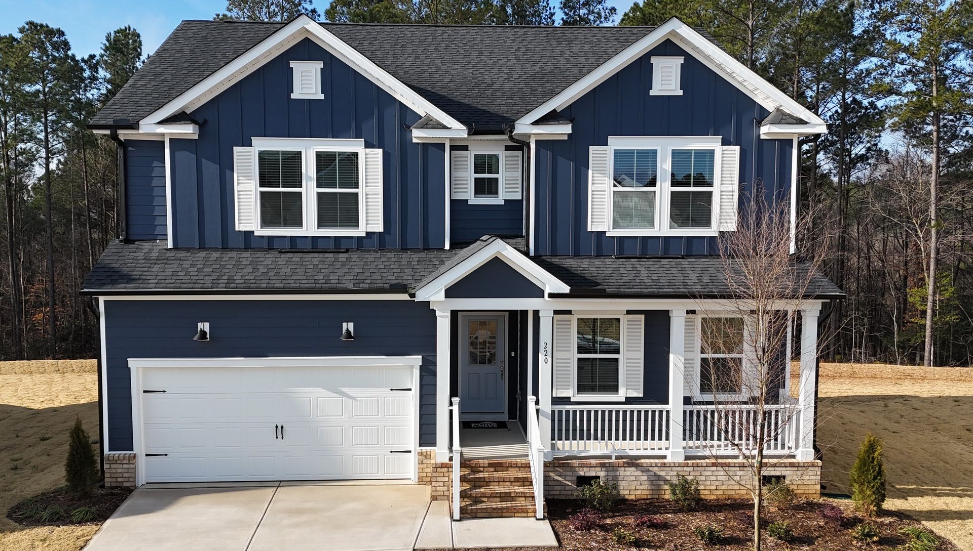 Blue board-and-batten new construction home in Wake County NC — pre-closing inspection by Sierra Delta